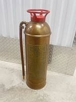 Full view of brass Imperial soda-acid fire extinguisher standing upright