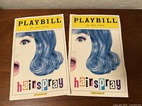 Front covers of both February 2006 Hairspray Playbills