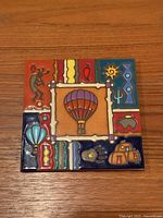 Front view of glazed ceramic trivet showing full Southwestern design