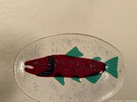 Front view of oval glass platter showing fused fish design