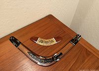 Large and small hand-painted wooden boomerangs on table