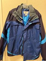 Front view of Columbia Omni-Tech jacket showing colorblocking, pockets, hood and zipper