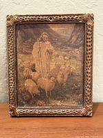 Front view of framed print showing image and carved frame details