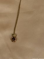 Full view of necklace with rose pendant and chain