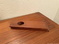 Oblique view showing teak holder profile and angled base