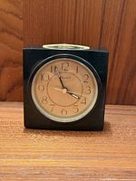 Front view of Seiko smoked lucite desk clock showing dial and case