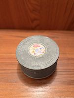 Lid view showing floral medallion and grey finish