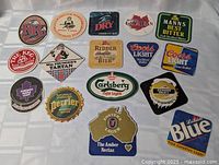All 15 advertising coasters laid out for overview