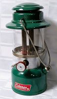 Front view of green Coleman 335 lantern showing globe, burner and handle