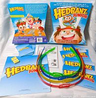 Front of Hedbanz Junior box with components laid out