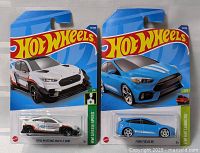 Both Hot Wheels cars in original blister packaging: Ford Mustang Mach-E 1400 and Ford Focus RS