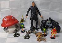 Group view showing all toys including mushroom house, action figure, Goofy, gorilla, aliens, soldiers, monkey, superhero