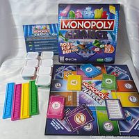 Complete Monopoly Chance game laid out with board, cards, trays, storage tubs, buildings, instruction sheet, and box