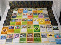 Wide view showing all 42 cards laid out in a grid with sleeves lined behind