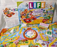 Box front, board, spinner, cards, buildings shown