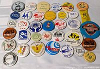 Overview of 34 assorted Kingston-area buttons laid flat