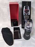 Full set showing aerator, stand, pouch, booklet, box and inner sleeve