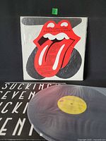 Front jacket in shrink with lips-and-tongue art and record partially shown