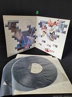 Gatefold jacket open displaying interior artwork and both vinyl discs in sleeves