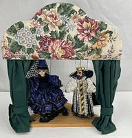 Full view of stage with both puppets hanging inside