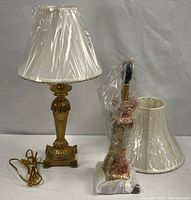 Both lamps, one fully wrapped, one partially unwrapped showing base and shade