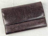 Front view of brown leather Coach wallet