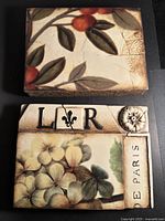 Front view of both tiles showing artwork, cracks and edge wear