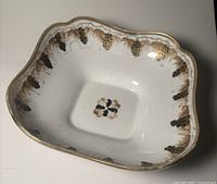 overall view of square scalloped porcelain dish with grapevine decoration