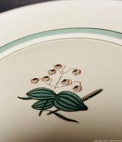 Close-up of central lily of the valley motif and inner green band