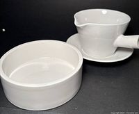 Arabia gravy boat on saucer beside Figgjo dish