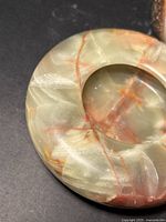 Round marble piece with recessed centre and visible veining