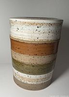 Full view of ceramic container showing glaze bands