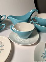 cup and saucer front, gravy boat rear, soup bowls stacked