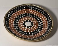 Top view of round mosaic dish showing full tile pattern and colors