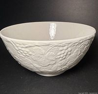 Side view of cream Burleigh mixing bowl showing relief pattern
