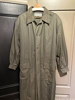 Full view of Giorgio Armani khaki trench coat hanging