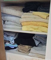 Full view of shelves showing assorted folded towels in various colours and sizes