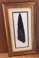 Full view of framed feather artwork