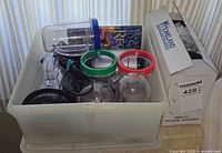 Overall lot in plastic tote with cups, blades, booklet and box visible