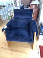 Front view of navy corduroy upholstered birch plywood armchair