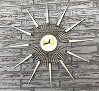 Full view of starburst wall clock mounted on wall