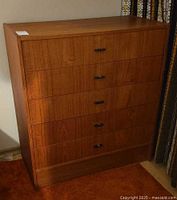 Front view of teak tallboy dresser showing five drawers