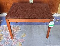 Full view of bench showing wood frame and upholstered top