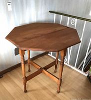 Table fully open showing octagonal top and leg details