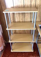 Front view of 4-shelf unit showing overall design and shelf spacing