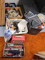 Overview of bins containing tools, hardware, toolbox, duct pieces