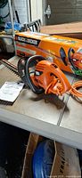 Trimmer, cord, box, manual on table