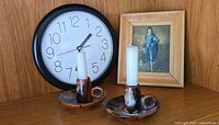 Pair of ceramic chamber sticks, wall clock, framed picture displayed together