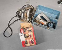 Overall view of circular saw, jigsaw with case, and Skil sander box