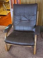 Front angled view of chair showing leather upholstery and bentwood frame